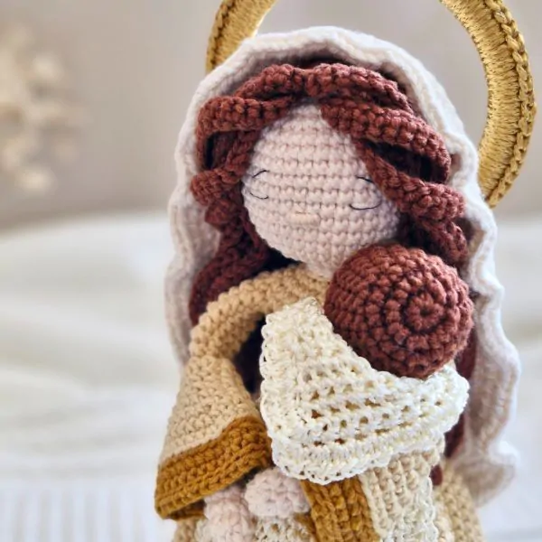 Detalhe de Maria com o Menino Jesus em amigurumi, mostrando textura e acabamento do crochê artesanal